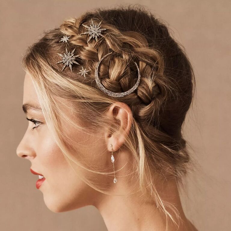 Model wears celestial hairpins in her braided updo. 