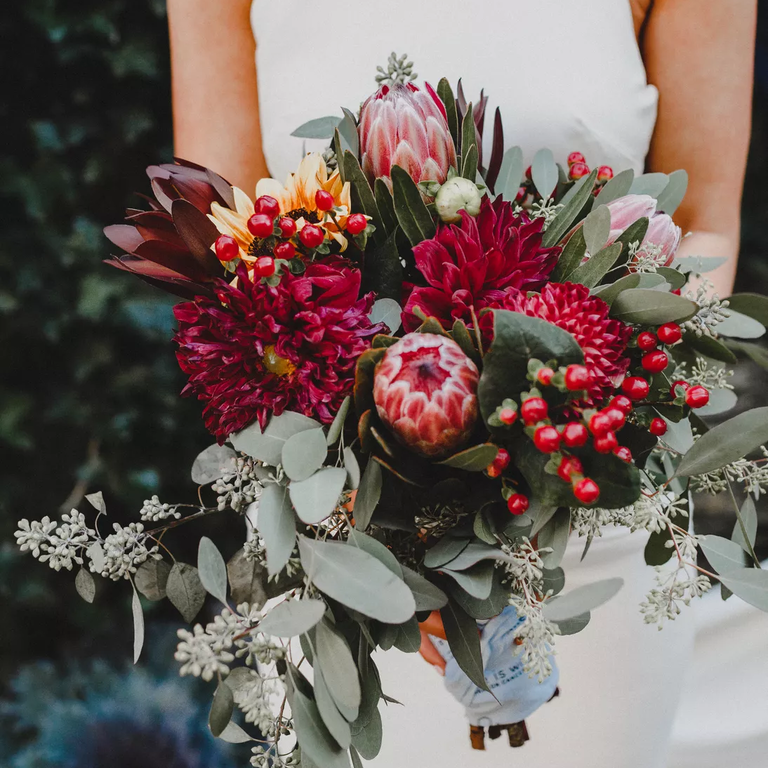 Protea and dahlia bouquet in wine tones