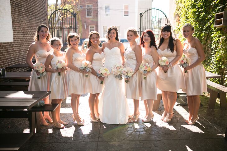 Elisa's bridesmaids wore strapless champagne Bill Levkoff cocktail dresses with matching colored heels.