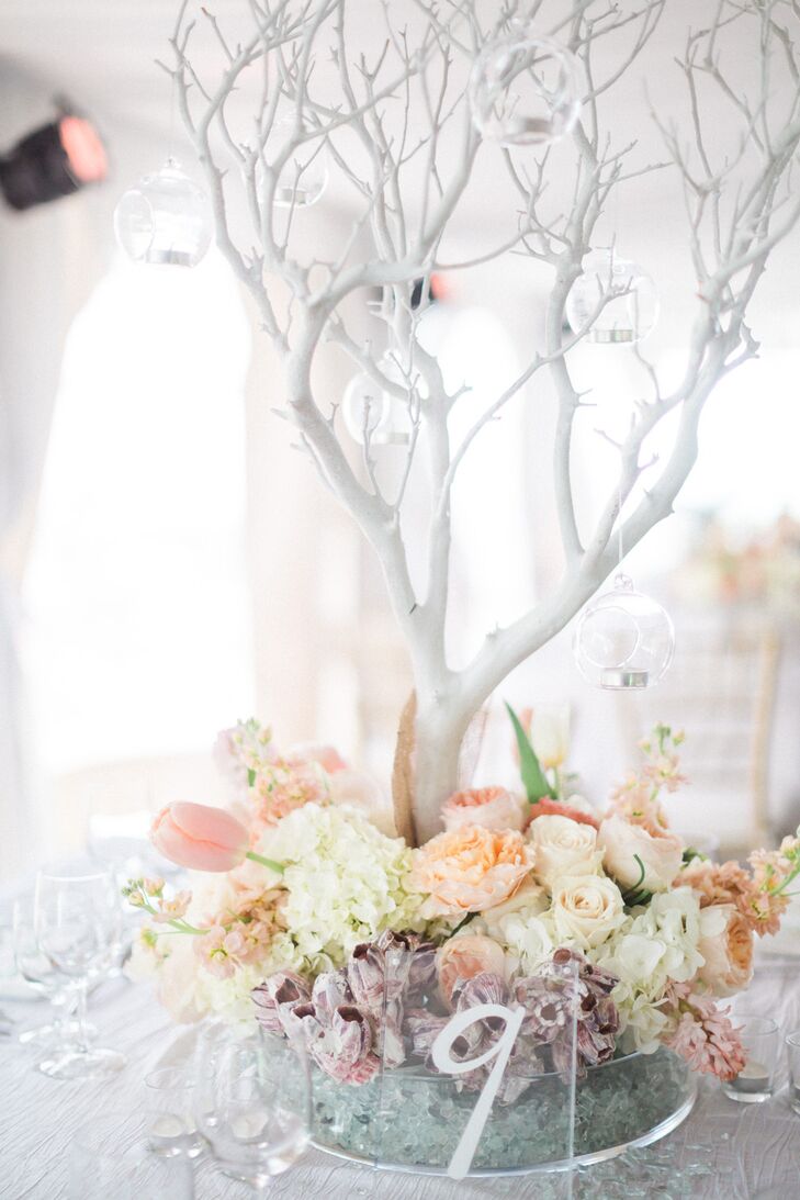 Their taller centerpieces were gorgeous! Each had this white manzanita branch with hanging glass orbs at the center of a pastel, spring arrangement. Pink tulips, white hydrangeas, pink delphiniums, white roses, and peach garden roses overflowed from its short cylinder vase.
