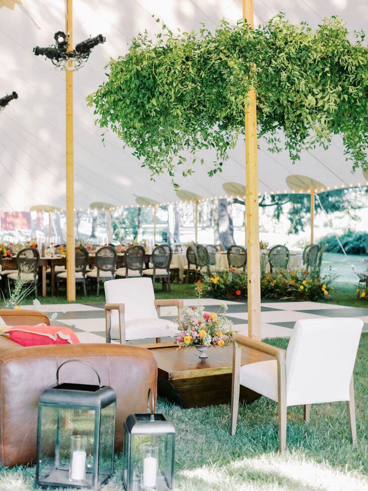 Lounge Space at Tented Reception Near Dance Floor Under Greenery Chandelier