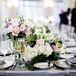 “I knew I wanted an interesting blend of flowers and textures and a growing-out-of-the-table feeling,” Rachel says. A mix of roses, hydrangeas and greenery in pinks, purples and whites were used to create whimsical floral arrangements.