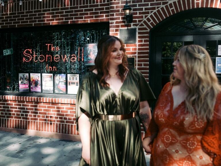 Couple standing in front of The Stonewall Inn in New York City