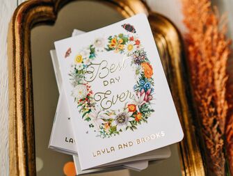 floral vow books with gold foil writing