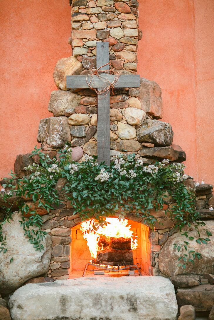 Rustic Cross on Stone Fireplace at Ceremony Venue