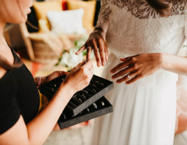 Woman being fitted for rings at Diamond Daughters INC in San Diego