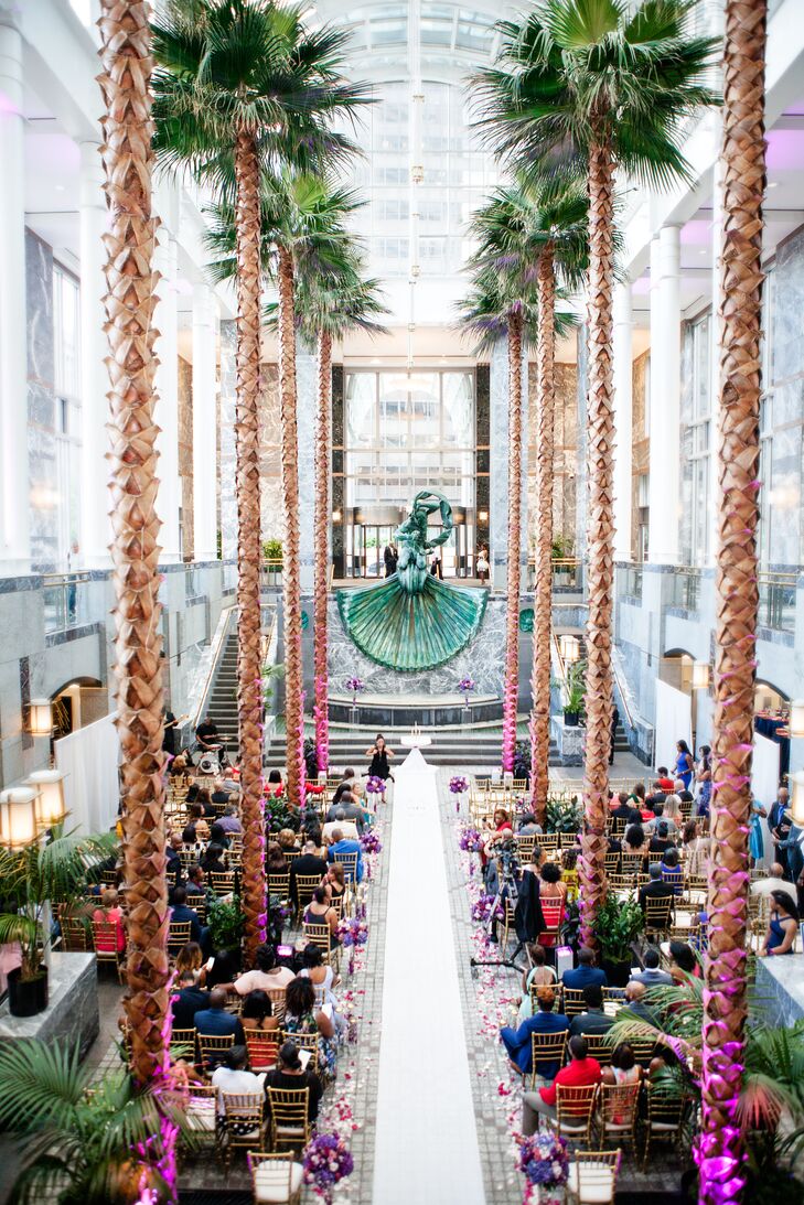 The indoor ceremony space at Pazzo's@311 in Chicago, Illinois, was lined with palm trees and illuminated by natural daylight.