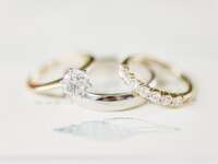 Solitaire engagement ring stacked with two wedding bands
