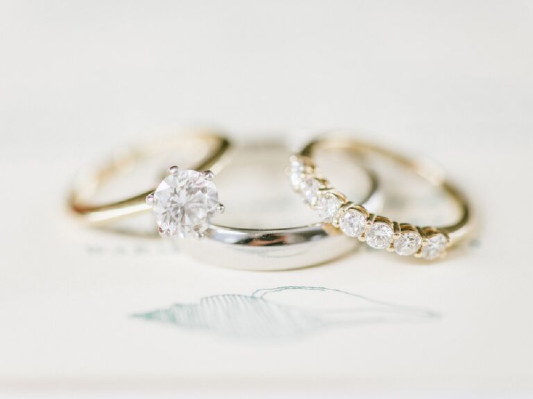 Solitaire engagement ring stacked with two wedding bands