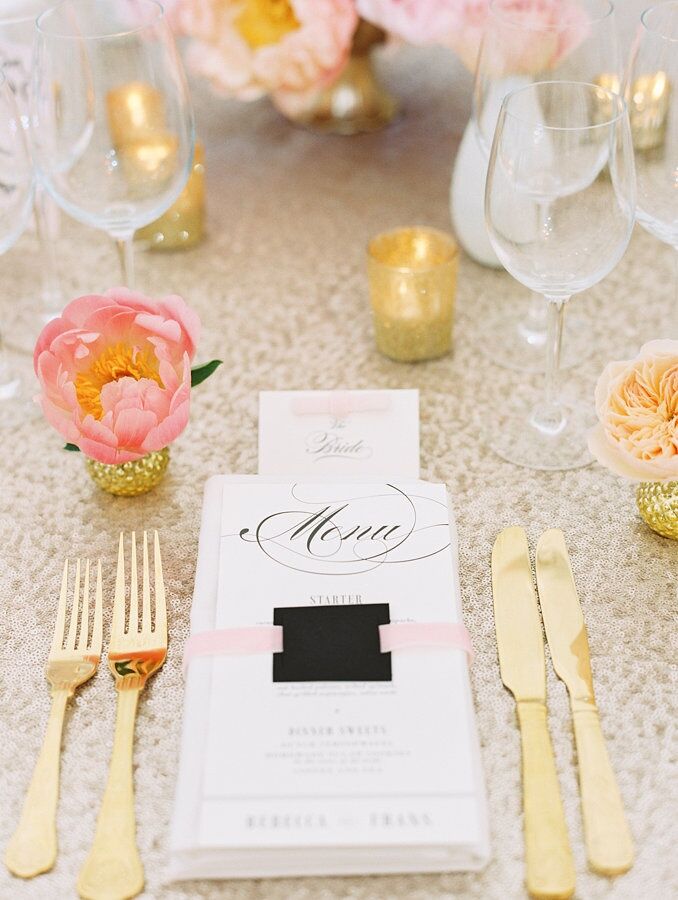 Gold cutlery and bud vases filled with large peonies and garden roses added a soft, romantic touch to the table decor.