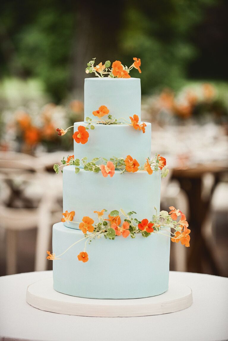 four-tier sky blue cake with orange nasturtiums