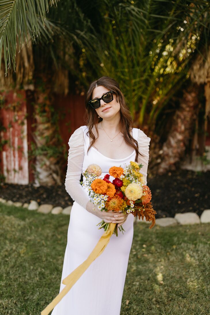 Bride in Modern, Sleek Wedding Gown and Minimalistic Jewelry With Bright Bouquet and Sunglasses