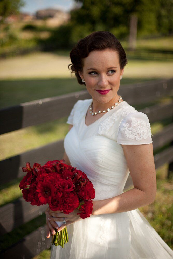 The bride channeled the past with her bold red lip and finger weave updo.