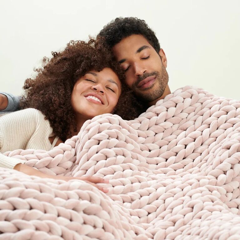 Couple snuggling under rose colored velvet weighted blanket anniversary gift for girlfriend