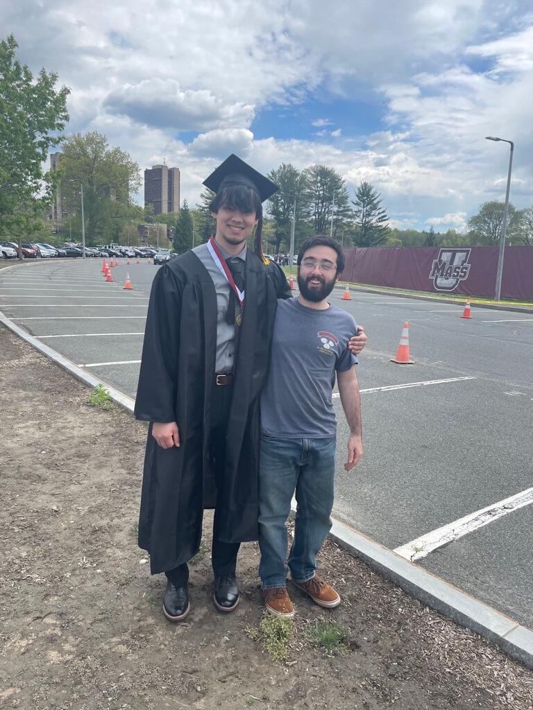 On this special day, Marlin graduated from UMass, and his family joined to celebrate the achievement. Here, you can see him with one of his little brother, Lucas, as they enjoy the moment together.