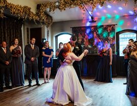 Bride and groom dancing surrounded by crowd