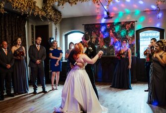 Bride and groom dancing surrounded by crowd