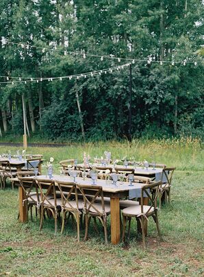 Western-Themed Wood Table With Simple Blue Runner and Glassware Under String Lights