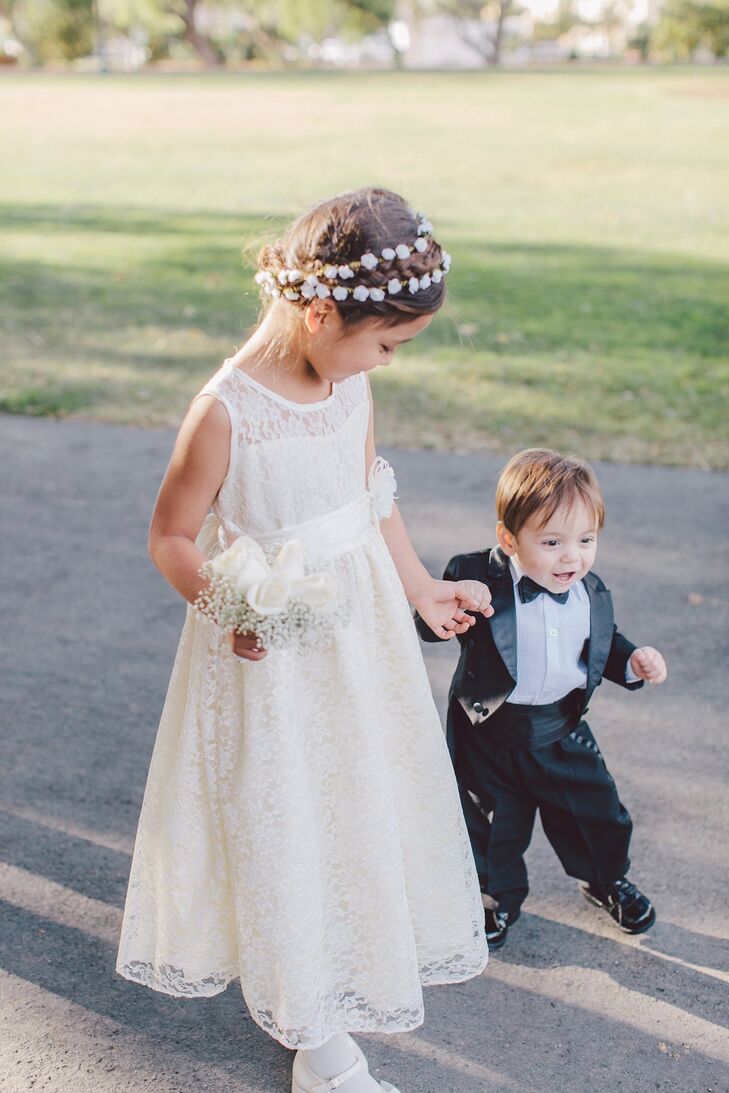 The flower girl wore a sleeveless lace dress and accessorized with flowers in her hair while the ring bearer sported a mini tuxedo.