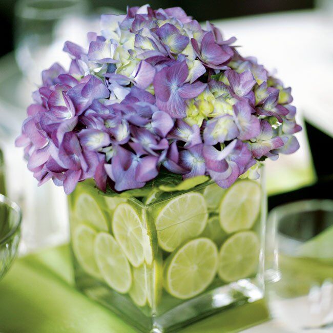 Rachel and Eddie opted for small, square, glass vases stuffed with sliced limes and purple hydrangeas to sit at the center of the tables.