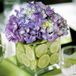 Rachel and Eddie opted for small, square, glass vases stuffed with sliced limes and purple hydrangeas to sit at the center of the tables.