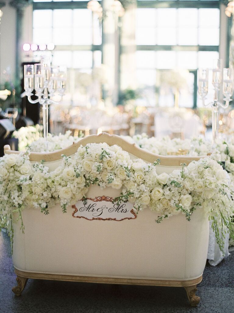 Mr. and Mrs. sweetheart seat with monochrome white flowers at regencycore wedding