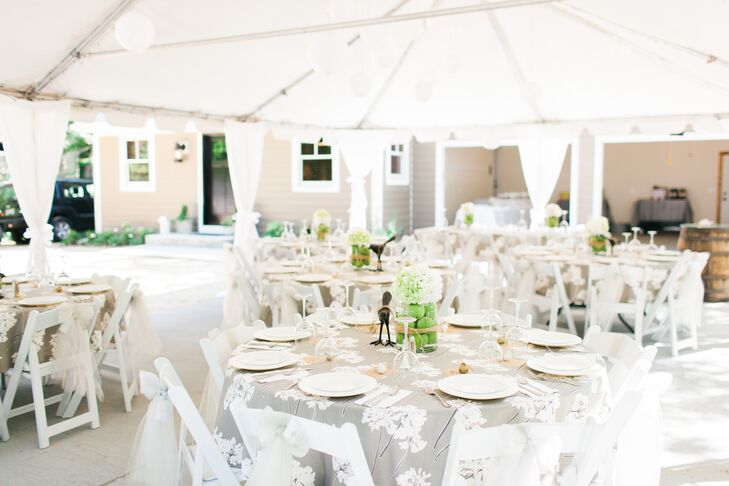 Gray linens covered in a white floral pattern covered the round dining tables. The centerpieces continued the bird motif with metal birds beside the hydrangea and apple arrangements, and a miniature bird figurine at each place setting.