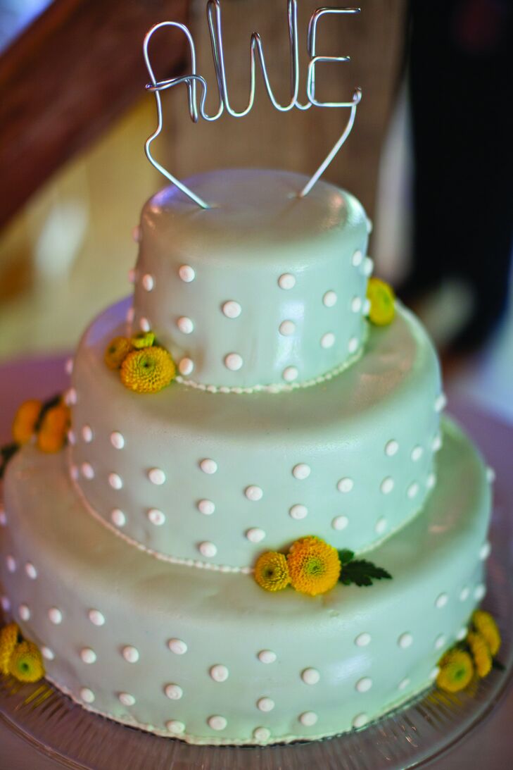 The gray-fondant cake was decorated with white dots, yellow flowers and a monogram cake topper.