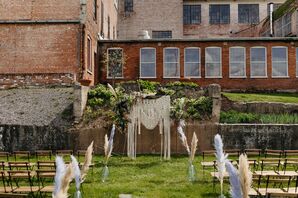 Wes Anderson-Inspired Wedding Ceremony With Macrame Altar, Flowers, Feather Aisle Decor