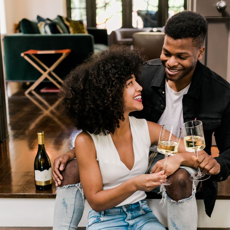 At-home engagement photo with white wine