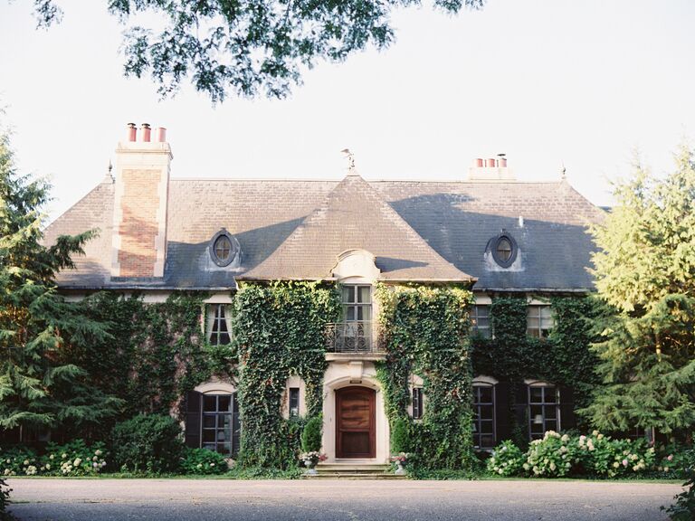 exterior of historic estate wedding venue cottage covered with ivy vines