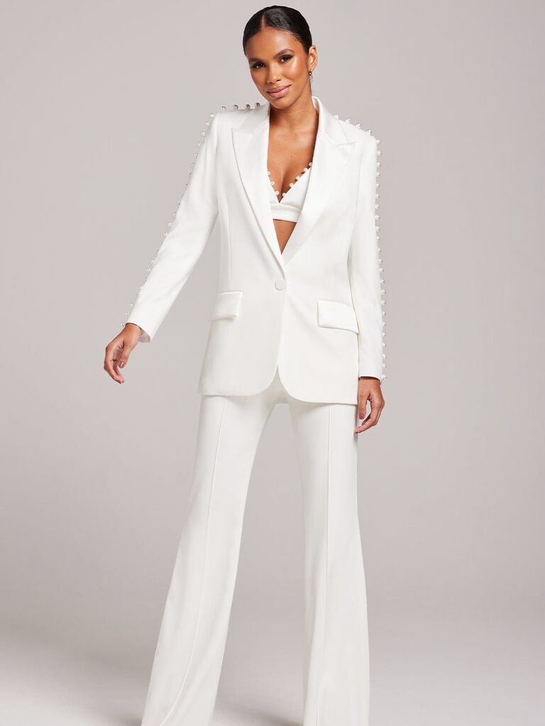 White pearl-embellished women's suit by Nadine Merabi. 