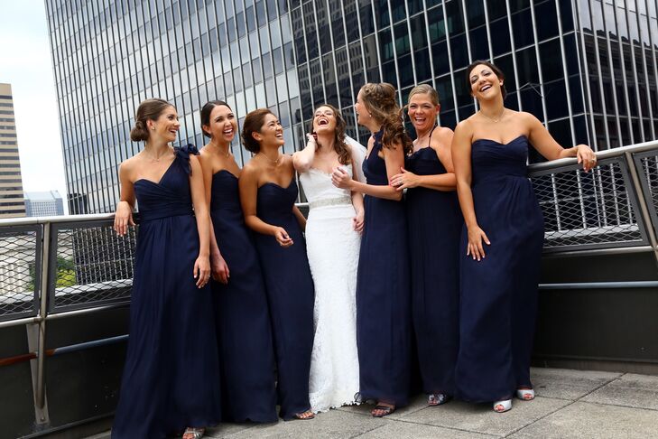 Kristen's bridesmaids wore coordinating Amsale gowns in dark midnight. Each 'maid clutched an arrangement of hydrangeas and roses.