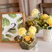 Table Number with Fig Leaf Illustration Alongside Geometric Centerpieces