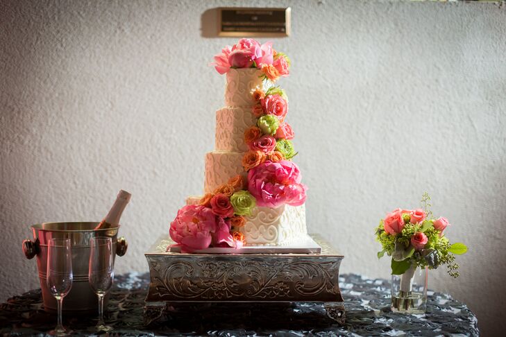 Even the wedding cake was given a colorful flourish, with vibrant pink peonies and color roses cascading down the sides.