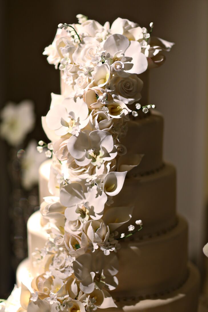 The beautiful white cake, designed by Cake Art, featured ornate cascading cake flowers that resembled orchids, calla lilies and roses. Kieran and Tom also served an extensive variety of cookies, ice cream, coffee and espresso for dessert.