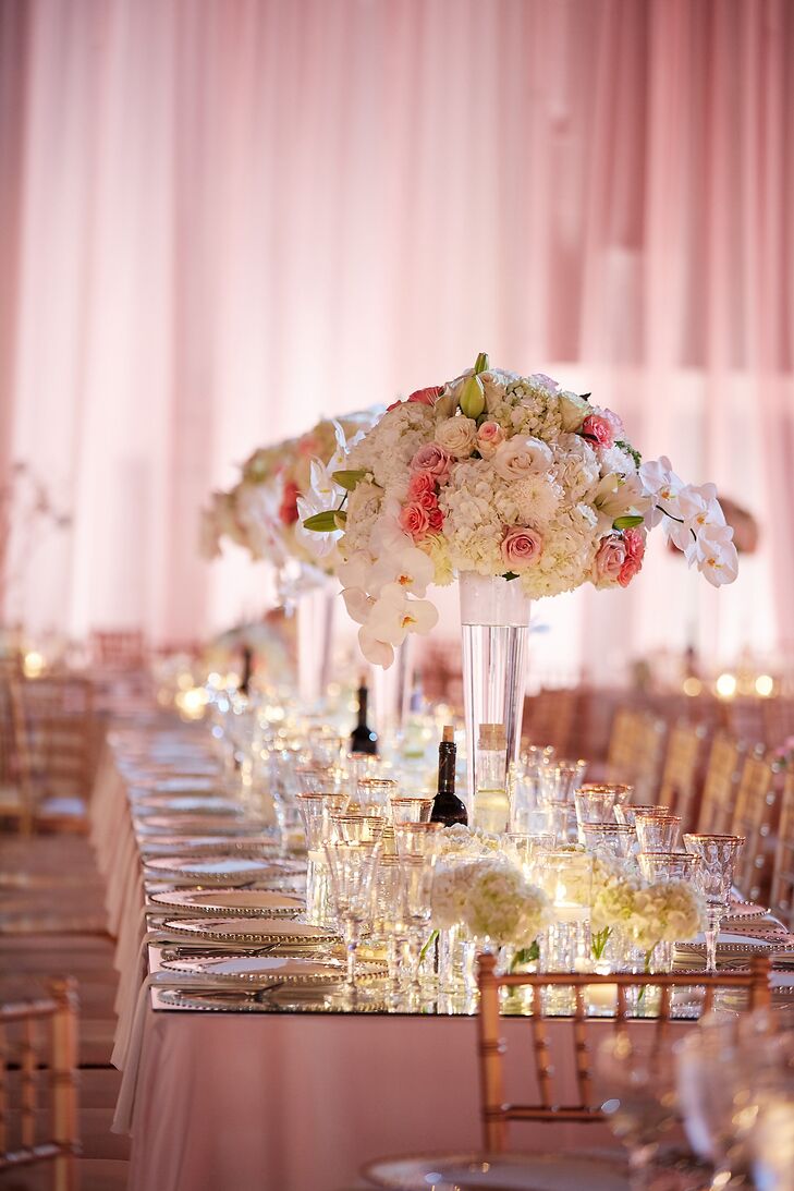 Maria and Chris decorated the four imperial head tables with table mirror toppers and three-foot towering rose, hydrangea and orchid centerpieces. “I wanted a classic, elegant look that was still dramatic,” Maria says.