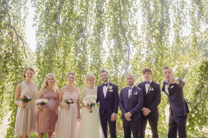 Linda's bridesmaids wore dresses of their choice in shades of blush and carried small pink bouquets. The groomsmen wore their own navy suits and blue bow ties.