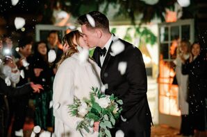 Groom in Tuxedo Kisses Bride in Formal Coat, Guests Throw Petals in Snow