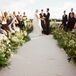 The aisle runner was a natural linen with the couple’s wedding logo of interweaving branches embroidered into it. The aisle was lined with tall greenery that came into a U around the ceremony site, where Katie and Cody exchanged vows in order to keep the view in the background the primary focus.