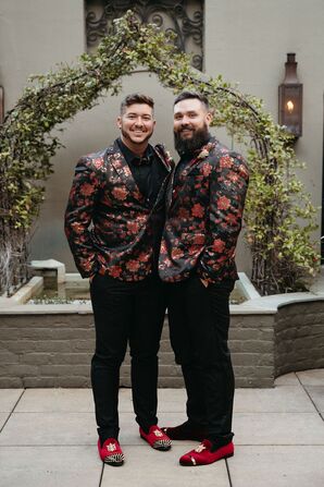 Two Grooms in Black Suit Jackets With Burgundy Flowers, Red Velvet Shoes