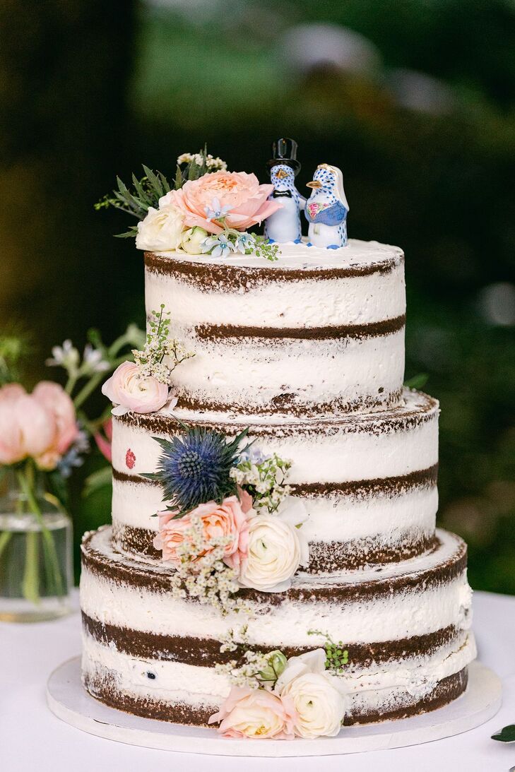 Three-Tier Naked Cake With Live Pastel Flowers and Penguin Cake Toppers