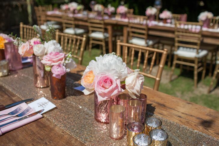 Renee Landry Events arranged white peonies, pink roses and peach garden roses to serve as the centerpieces. Sparkly gold table runners, metallic vases and gold chiavari chairs added plenty of glamour to the wooden farm tables.