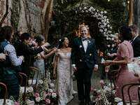 Bride wearing intricate floral lace off-the-shoulder dress