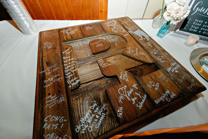 The guest book was made from recycled wooden pallets. “We wanted to be able to display something in our home from the wedding day, and this was the perfect way to remember our wedding and our guests,” the bride says.