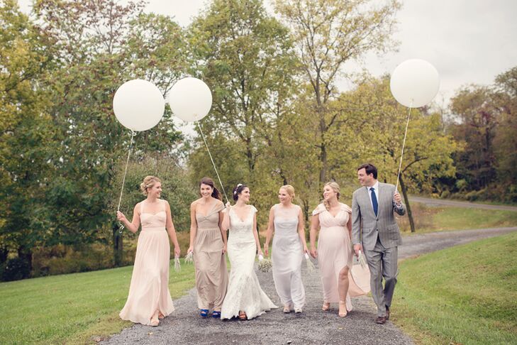 Once Erin gave her bridesmaids and bridesman a gold, neutral, blush, pale blue and mint color palette, they were free to pick any outfit of their choosing. Each woman chose a long, light-colored gown with a sweetheart neckline. Erin's brother had something a little extra special in mind. "My brother wore the same suit he wore to his own wedding just four months earlier," she says.