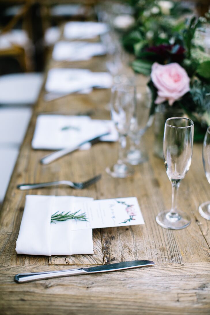 Each rustic farm table was topped with assorted glassware, airy flowers and lush greens.