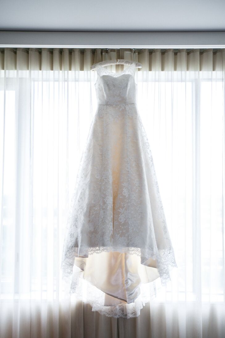 Katherine purchased her Elizabeth Todd gown in London, England while working abroad. The A-line dress is ivory satin with a lace overlay and a boat neckline.