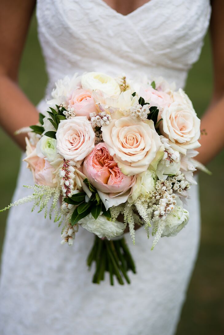 “I am a traditional girl who loves textures,” Caitlin says. “The flowers had lots of depth and shape.” The couple's florist from Beautiful Days complemented their natural farm setting with a stunning bouquet filled with pink hues and lush greenery. A mixture of ivory and blush roses, pink garden roses, Japanese pieris, white ranunculus and white astilbes were included in the arrangement.
