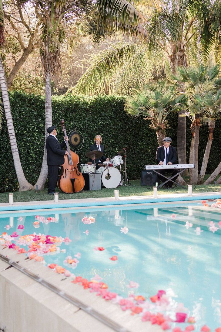 Small Band With Drums, Cello, Keyboard Behind Pool With Flower Petals at Estate